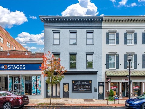 A street view with a building that has a sign that says "STAGES" on it.