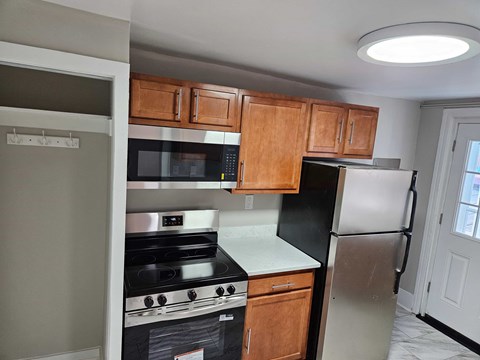 A kitchen with a black refrigerator and stove.