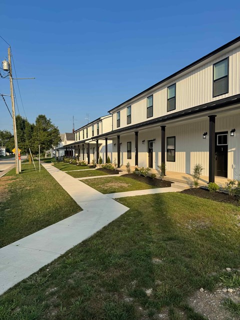 A long building with a walkway in front.