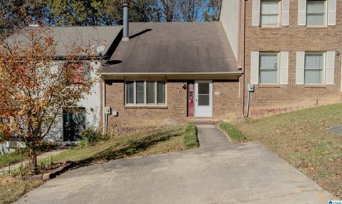 A house with a red door and a brown roof.