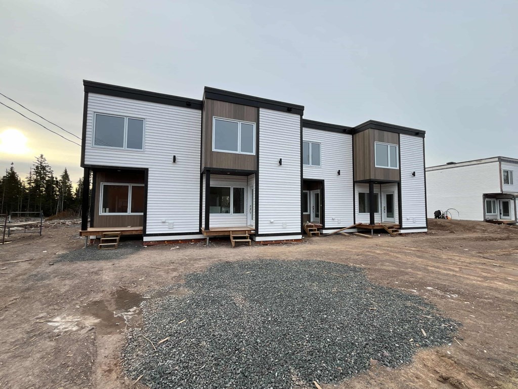 A row of new houses are being built in a housing development.