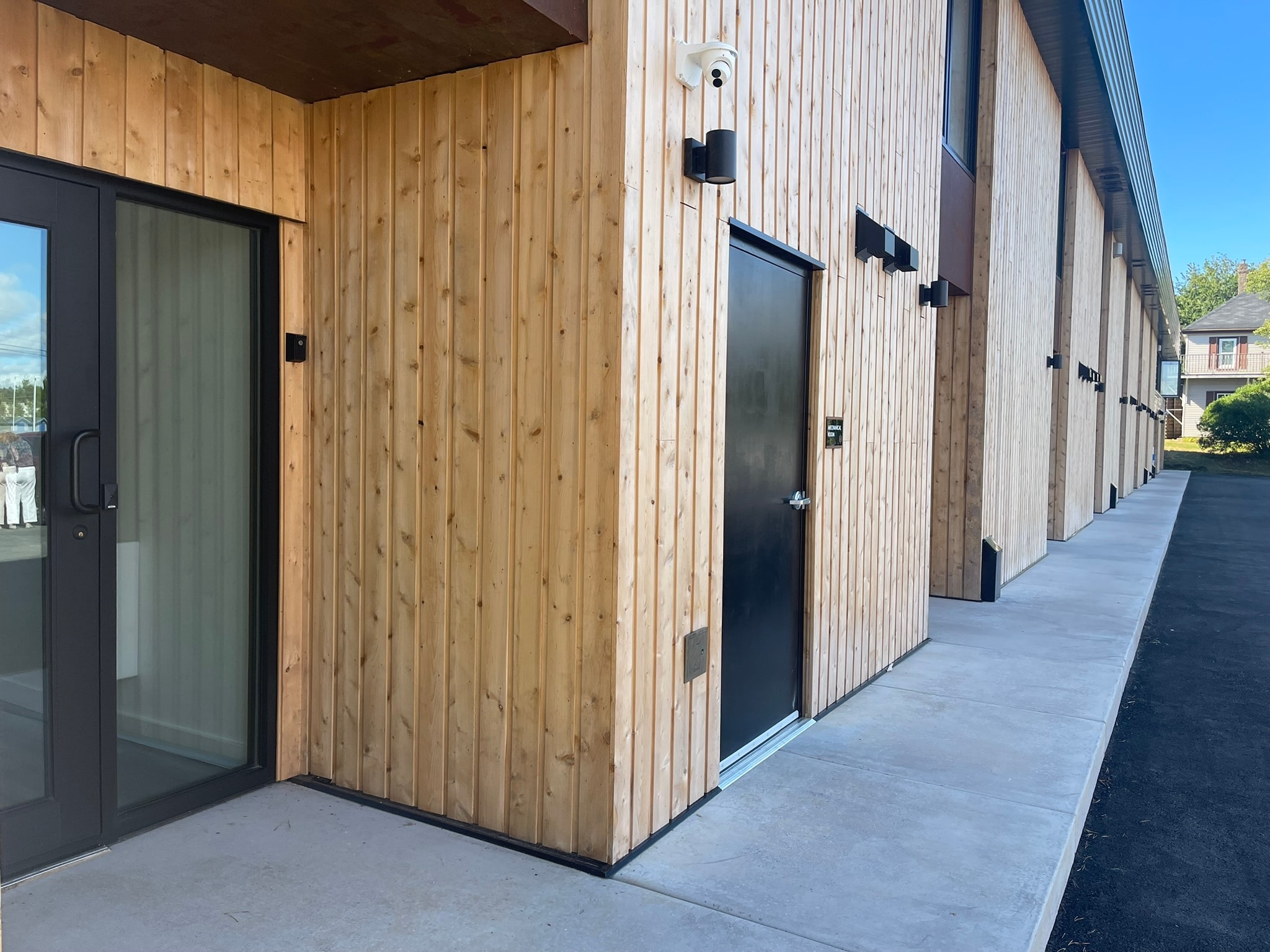 A building with wooden walls and black doors.