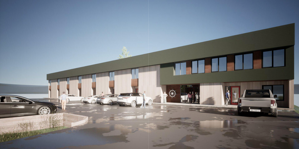 A modern building with a parking lot in front.