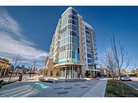 A modern multi-story building with a glass facade is the main focus of the image.