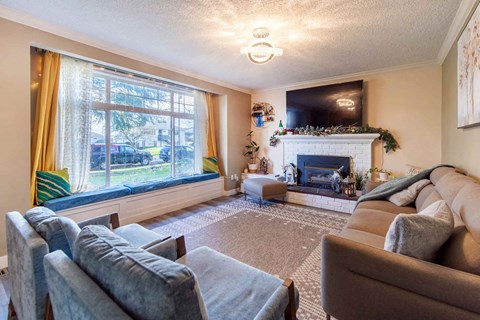 A living room with a fireplace and a flat screen TV.