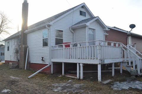 A house with a white porch and a red door.