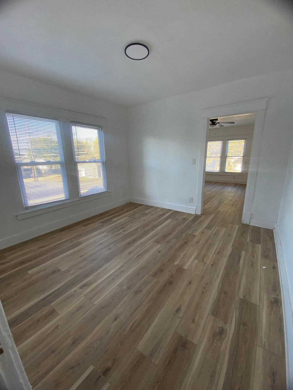 A room with wooden flooring and a window.