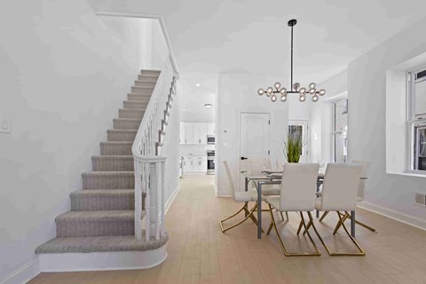 A dining room with a table set for four.
