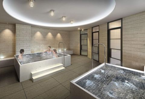 A modern indoor swimming pool with people in it.