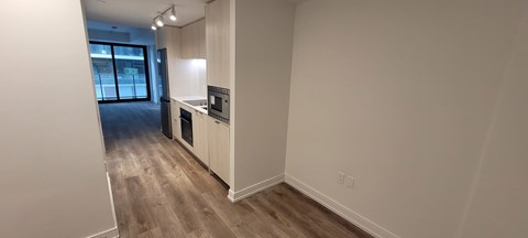 A kitchen area with a counter and a fridge.