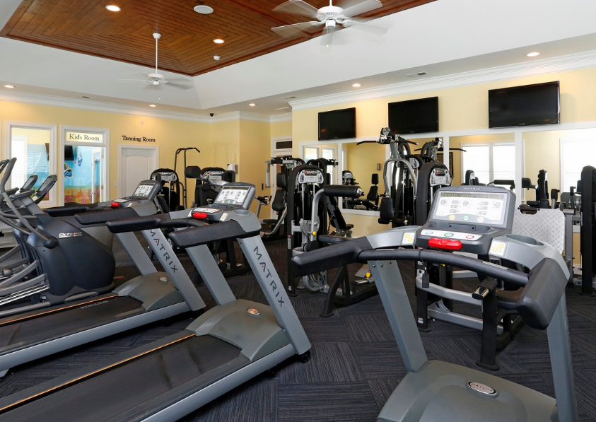 a gym with various treadmills and other exercise equipment