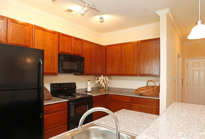 a kitchen with black appliances and granite counter tops