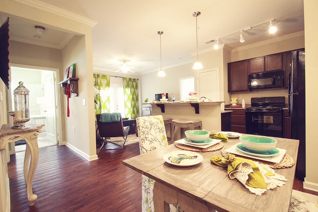a kitchen and dining room with a table and chairs