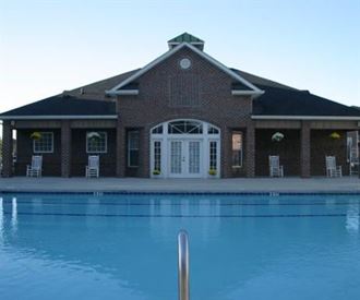 a large swimming pool in front of a building