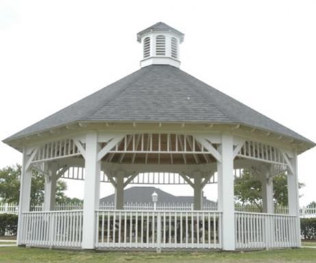 a white gazebo with a roof and a white fence