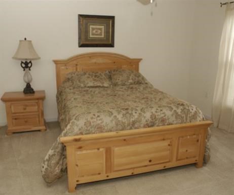 a bedroom with a bed and two night stands