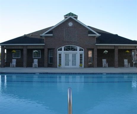 a large swimming pool in front of a building