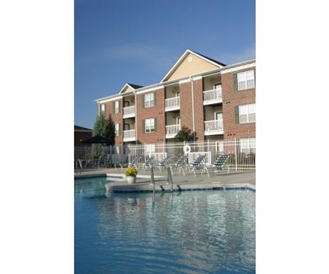 a large pool of water in front of an apartment building