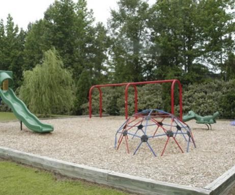 a playground with a swing set and other playground equipment