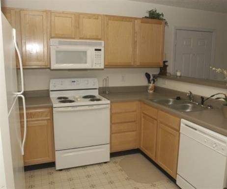 a kitchen with a stove microwave and sink