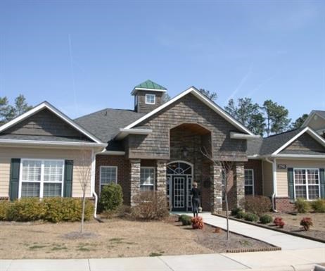 A house with a green roof and a brick facade.