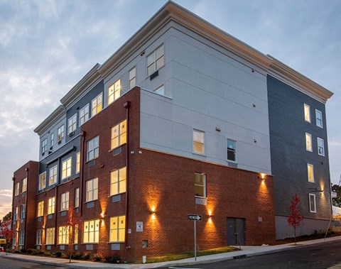 A modern building with a mix of brick and panel exterior.