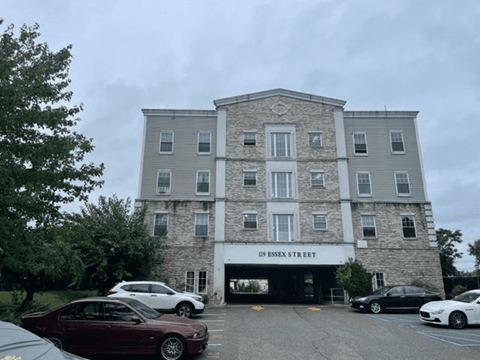 A building with the name "B Essex Street" is visible with cars parked in front.