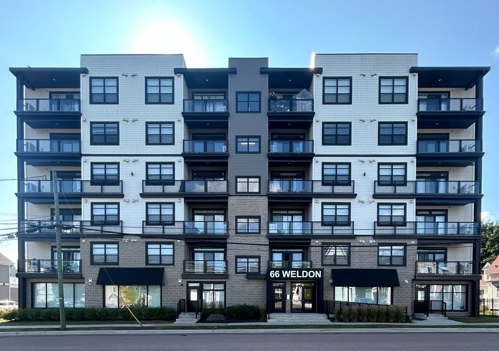 The image shows a multi-story building with the name "66 WELDON" on the front.