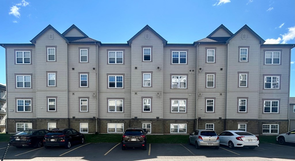 A large building with a parking lot in front of it.