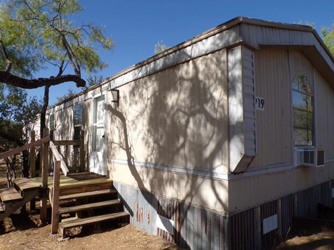 A house with a tree in front of it.