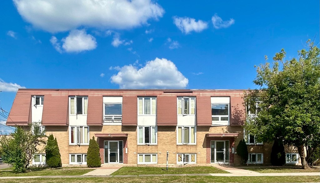 A red brick building with white trim and windows.