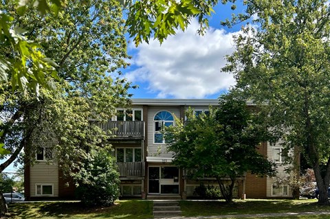 A large two story apartment building with a balcony on the second floor.