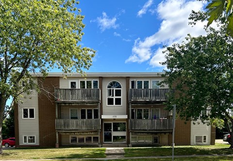 A large apartment building with a balcony on the second floor.