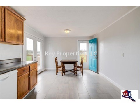 A kitchen with wooden cabinets and a dining table.