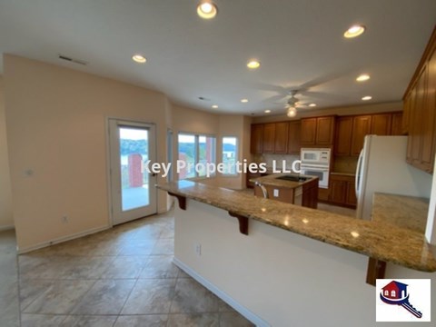 A kitchen with a counter and a window.