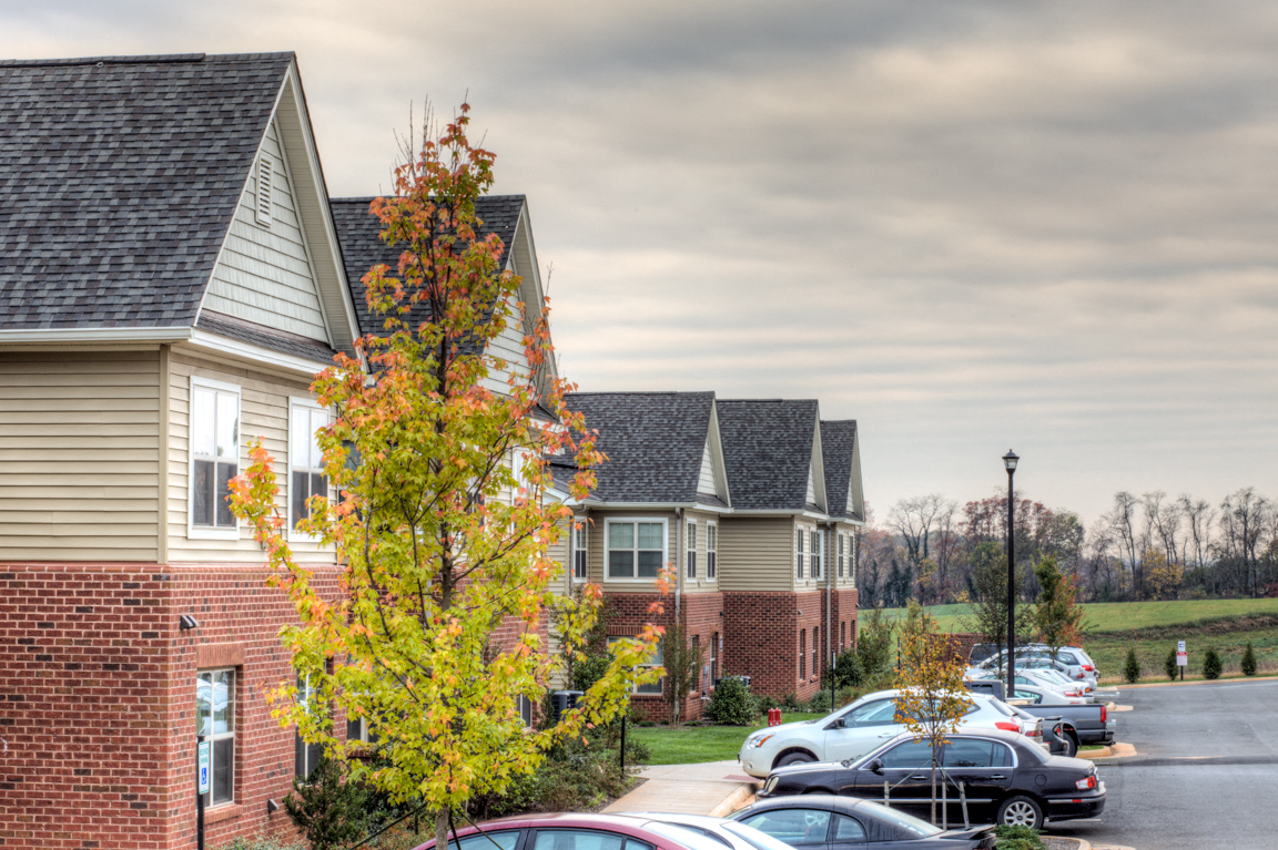 a row of houses in front of a parking lot