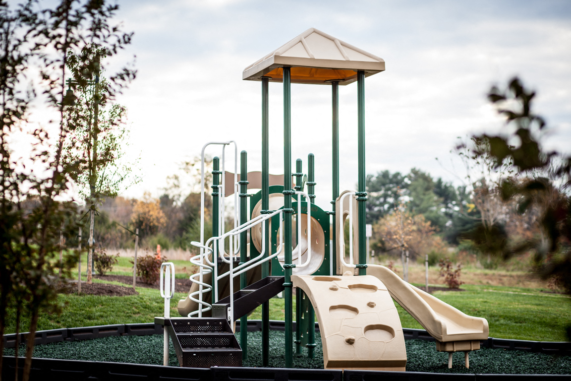 a playground with slides and climbing equipment in a park