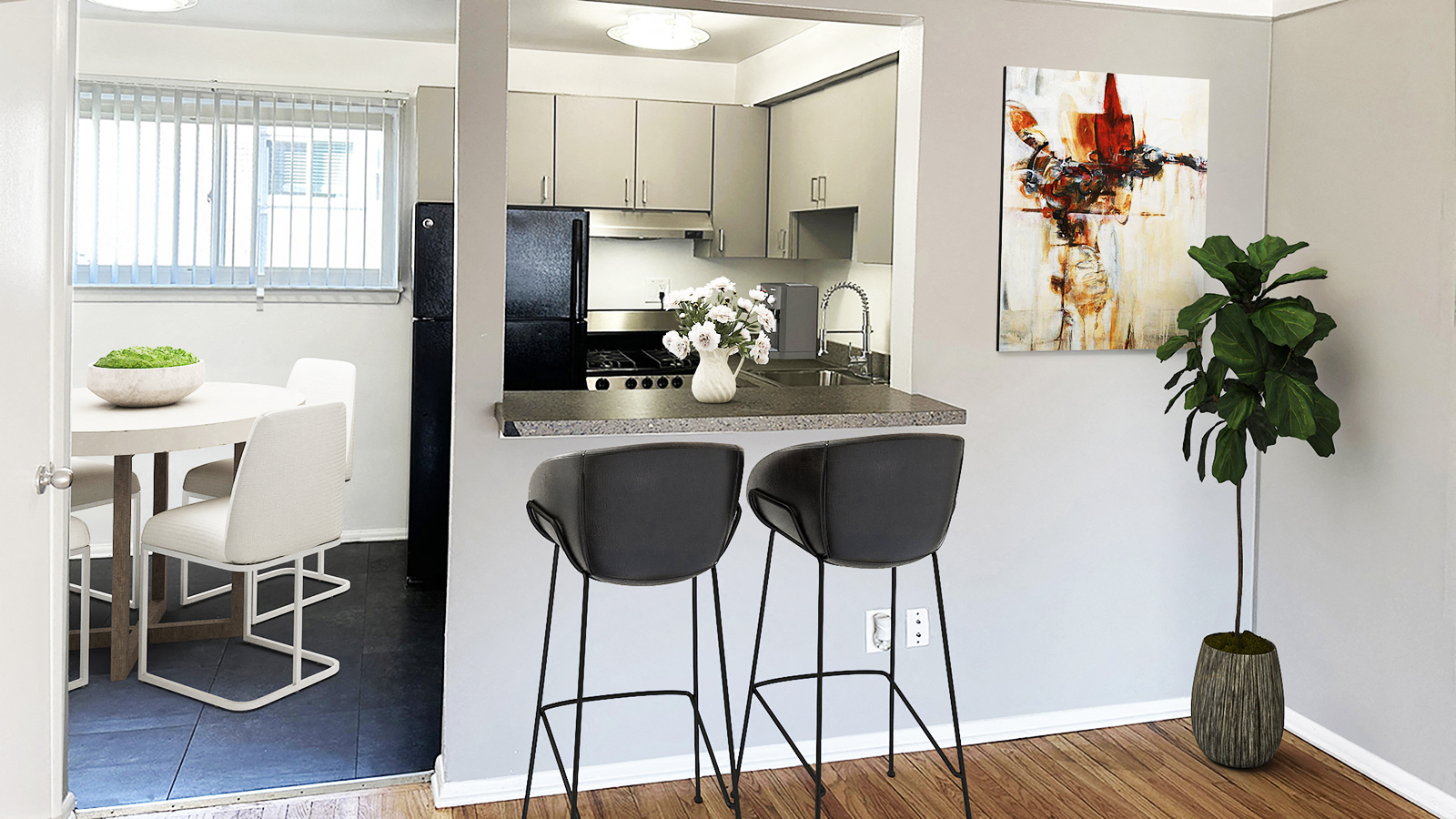 A kitchen with a bar stool and a plant.