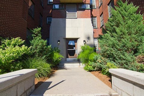 A concrete pathway leads to a building entrance.