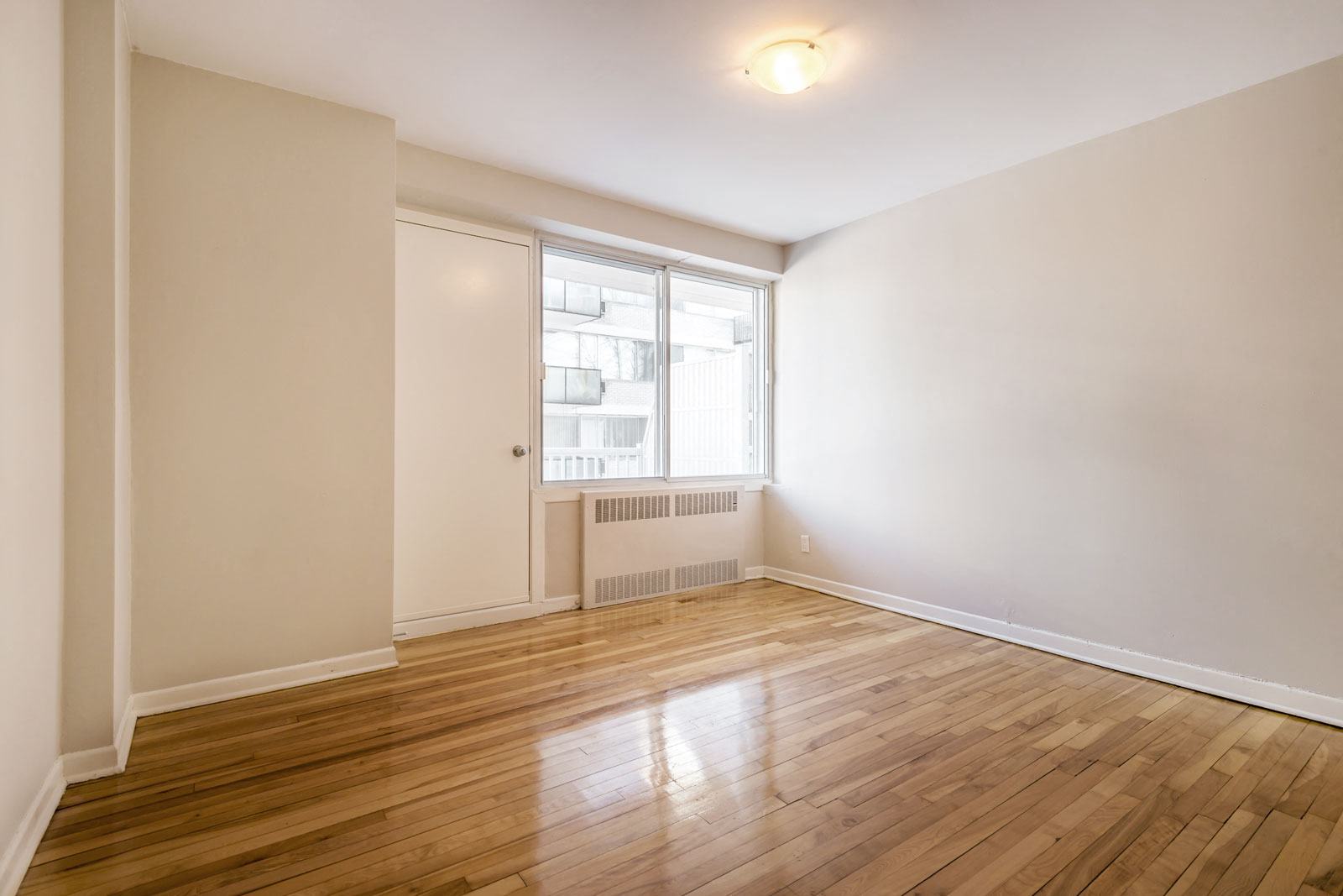A room with wooden floors and a window.