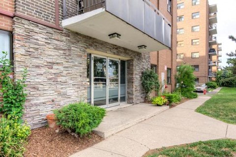 A building with a stone facade and a glass door.