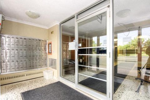 A glass door with a black mat in front of it.