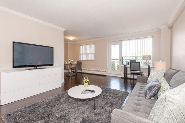 A living room with a grey couch and a flat screen TV.