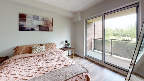 A bedroom with a large bed and a painting on the wall.