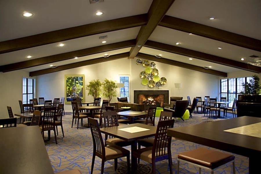 a large dining room with tables and chairs and a fireplace