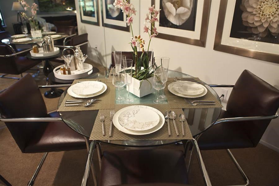 a dining room table with plates and chairs