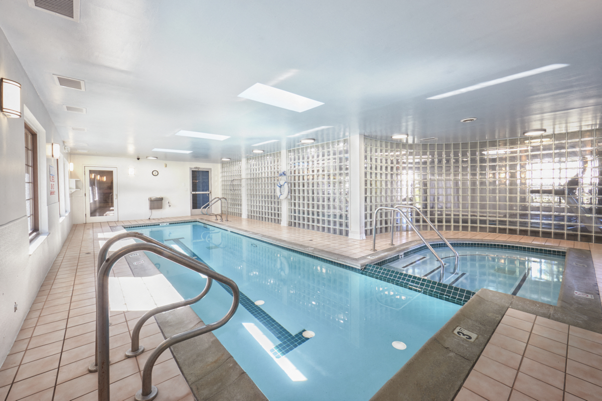 a swimming pool in a hotel with a glass fence around it