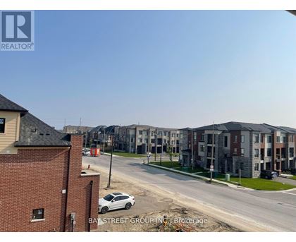 A view of a street with apartment buildings and a car parked on the side of the road.