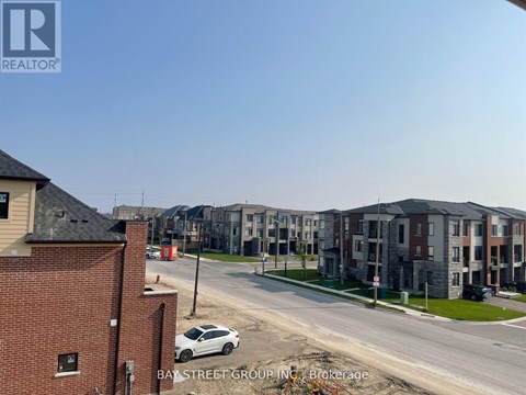 A view of a street with apartment buildings and a car parked on the side of the road.