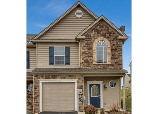 A house with a blue door and a garage door.